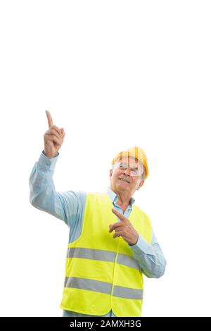 Trustworthy male old builder pointing index finger at blank copyspace above isolated on white background Stock Photo