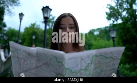 Lady tourist using map for navigation, lost in unfamiliar place, sightseeing Stock Photo