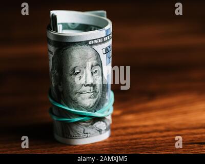 One hundred dollar bills on a table. Copy space. Stock Photo