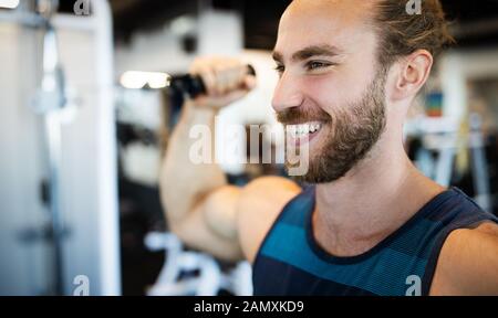 Fitness, sport, exercising and lifestyle concep Young man working out in gym Stock Photo