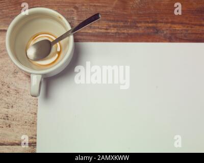 coffee cup, top view of the table and a blank sheet of paper, copy space Stock Photo