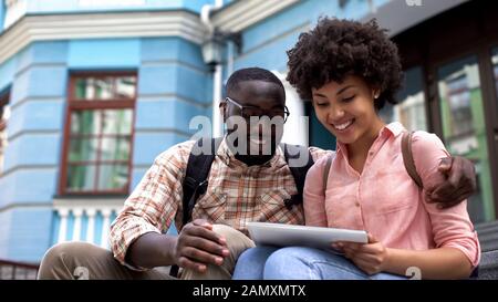 Tourists using travel guide application tablet, educational program for students Stock Photo
