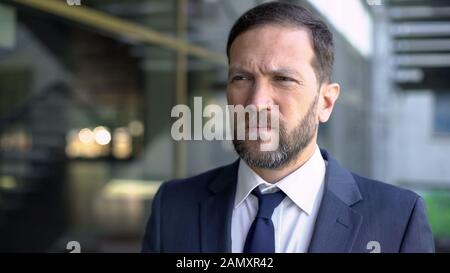 Worried office worker close up, thinking over important deal, stressed lifestyle Stock Photo