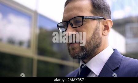 Office manager in eyeglasses close up, worried about business problems, work Stock Photo