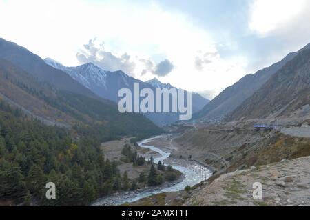 Baspa River flowing through Sangla Valley Chitkul, most scenic upper and middle hill slopes of Himalayas mountain range near Indo-Tibetan border cover Stock Photo