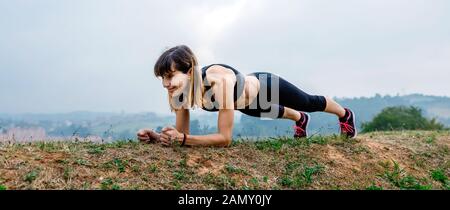 Panoramic banner. Happy young and sporty woman doing sport exercises at gym  with an overlay of the word EXERCISES. Isolated on white background.  Panoramic banner. Sport. Healthy lifestyle. Fitness Stock Photo 
