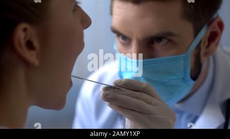 Female patient coughing at otolaryngologist examination, flu epidemic healthcare Stock Photo