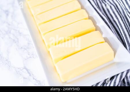 Organic sticks of butter at the room temperature. Stock Photo