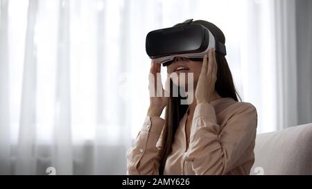 Surprised girl using VR headset for first time, overwhelmed with emotions Stock Photo