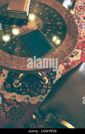 Digital tablet on wooden desk with dark wood background Stock Photo