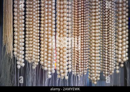 strings of beads from natural freshwater pearls in market Stock Photo