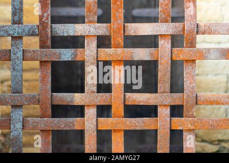 An iron wicker rusty grill at the entrance to an antique building. No entry. Security and Restriction Concept Stock Photo