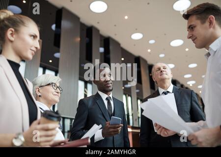 Group of business people working in team they standing and discussing business plan with their leader at office Stock Photo