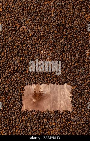 Background texture of dark wooden  board and frame of coffee beans - image Stock Photo