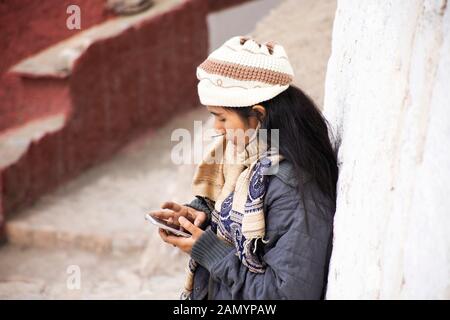 Travelers thai women people travel visit relax and use mobile phone take photo Thiksey monastery and Namgyal Tsemo Gompa in Jammu and Kashmir, India i Stock Photo