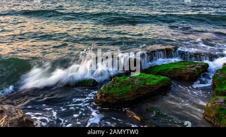 Waves crashing on the rocky seashore Stock Photo
