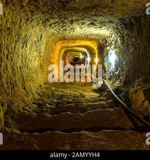 Mysterious dungeon- tunnel with walls made of stone Stock Photo