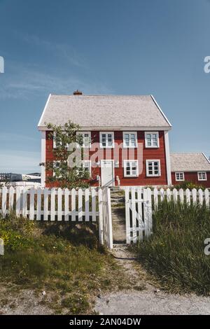 Nuuk city of Hanse Egede. Capital of Greenland. Colorful inuit houses in a suburb of arctic capital Nuuk. The old hospital - school at the waterfront Stock Photo