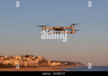 Catalonia, Spain - Jan 11, 2020: DJI mavic mini flying near the coast at sunset. Stock Photo