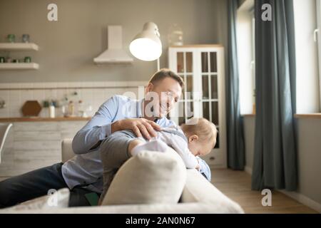 Mature father spending his time at home with his kid Stock Photo