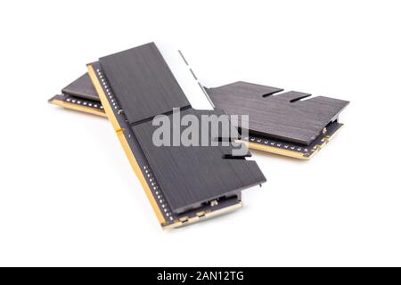a pair of ddr4 dimm pc ram memoty modules with stylish black heatsinks - isolated on white with selective focus. Stock Photo