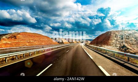 Travel adventures and leisure. Road and cloudy sky. Scenic landscape and country road. Stock Photo