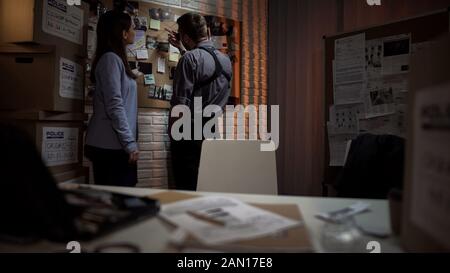 Police office colleagues working together on crime investigation in office Stock Photo