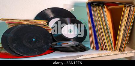 45 and 33 rpm vinyl discs stack on white background Stock Photo