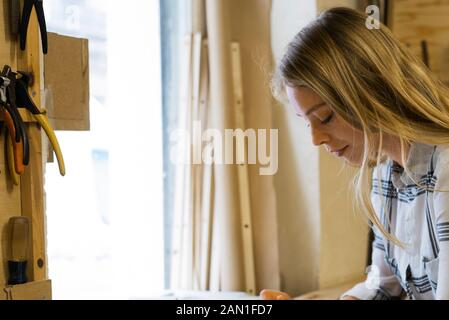 Woman using digital tablet in workshop Stock Photo