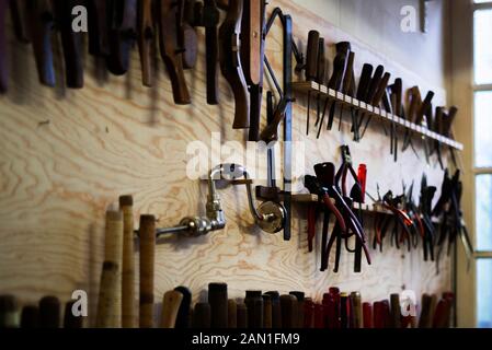 Hand tools hanging on pegboard Stock Photo