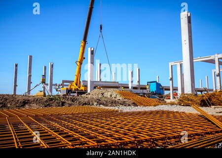 View on rusty square reinforcement for concrete, construction site is in background. Stock Photo