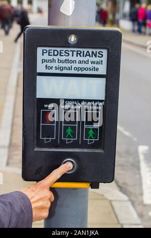 8 June 2017 A female hand pressing the control button of a Pelican Crossing in the United Kingdom Stock Photo