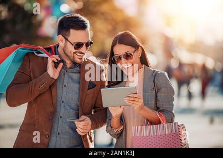 Happy couple using digital tablet together.People,love,technology  and consumerism concept. Stock Photo
