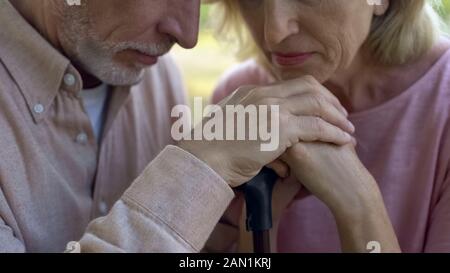 Elderly couple leaning on walking stick, strong marriage, support of pensioners Stock Photo