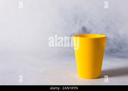 group color plastic cups on gray stone background plastic waste Stock Photo