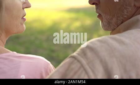 Elderly couple looking each other closeup, mutual understanding, affection Stock Photo