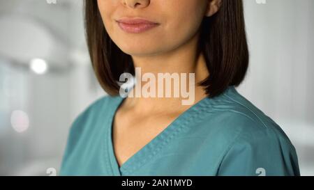 Young female nurse posing for camera, professional help from qualified doctor Stock Photo