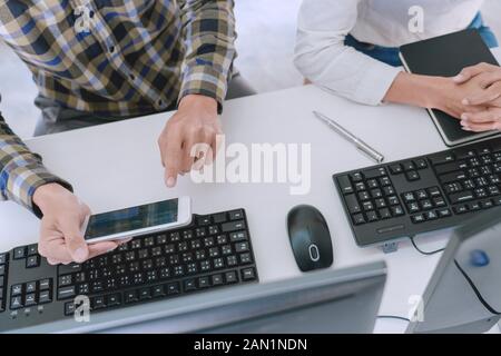 Pensive programmer working on desktop pc programming code technologies or website design at office Software Development Company Stock Photo