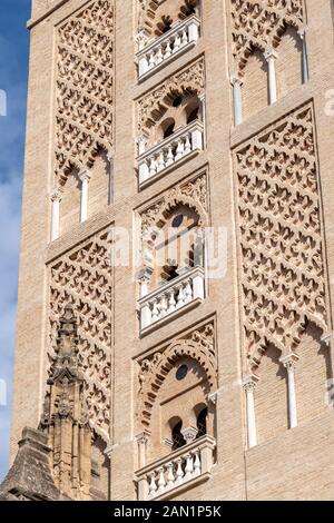 The Almohad decoration of the main section of the Giralda tower of Seville Cathedral clearly shows its Moorish origins as the minaret of the mosque. Stock Photo