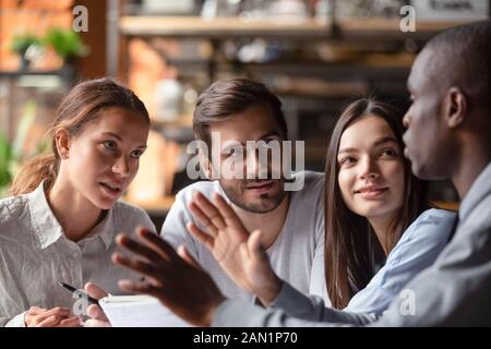 Multiracial young people meeting in cafe studying together Stock Photo