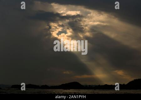 Sunlight shining through dark clouds Stock Photo