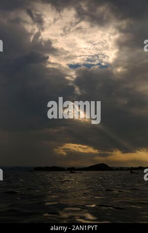 Sunlight shining through dark clouds Stock Photo