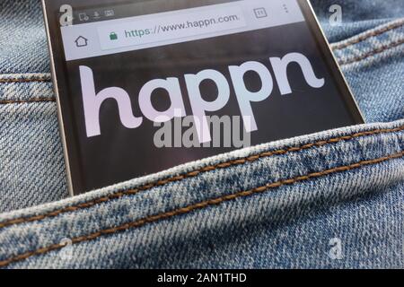 Happn website displayed on smartphone hidden in jeans pocket Stock Photo