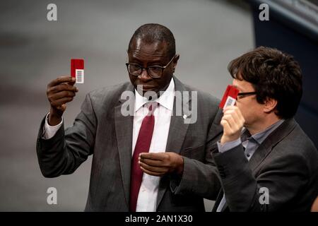 Berlin, Germany. 15th Jan, 2020. Karamba Diaby (l)(SPD), Member of the Bundestag, is in the plenary chamber during the vote on the mandate for the deployment of armed forces in Iraq. According to the Bundestag member, his citizens' office in Halle has been shot at. Credit: Fabian Sommer/dpa/Alamy Live News Stock Photo