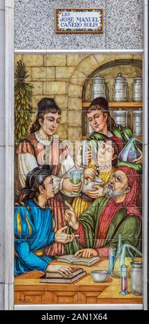 A highly colourful azulejos image on the wall of a pharmacy in Seville Stock Photo