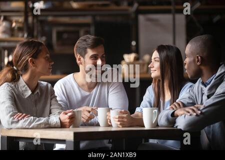 Diverse young people meeting in cafe drinking coffee Stock Photo