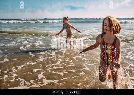 action shot of girls playing in water on huntington beach