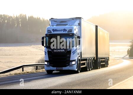 White Next Generation Scania of Kuljetus Ylilammi Oy pulls trailer uphill along scenic highway on a foggy day of winter in Salo, Finland. Jan 10, 2020 Stock Photo