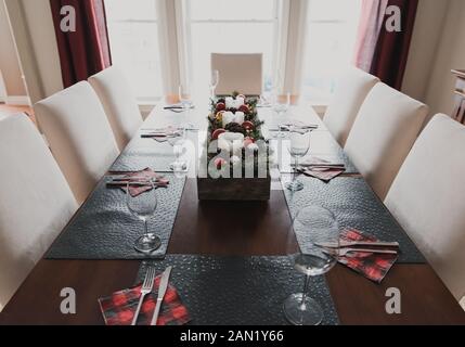 Close up of a dining table set for a Christmas holiday dinner. Stock Photo