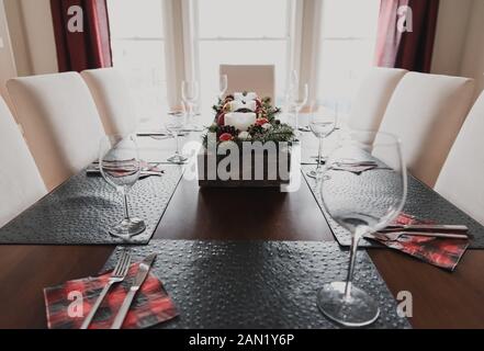 Close up of a dining table set for a Christmas holiday dinner. Stock Photo